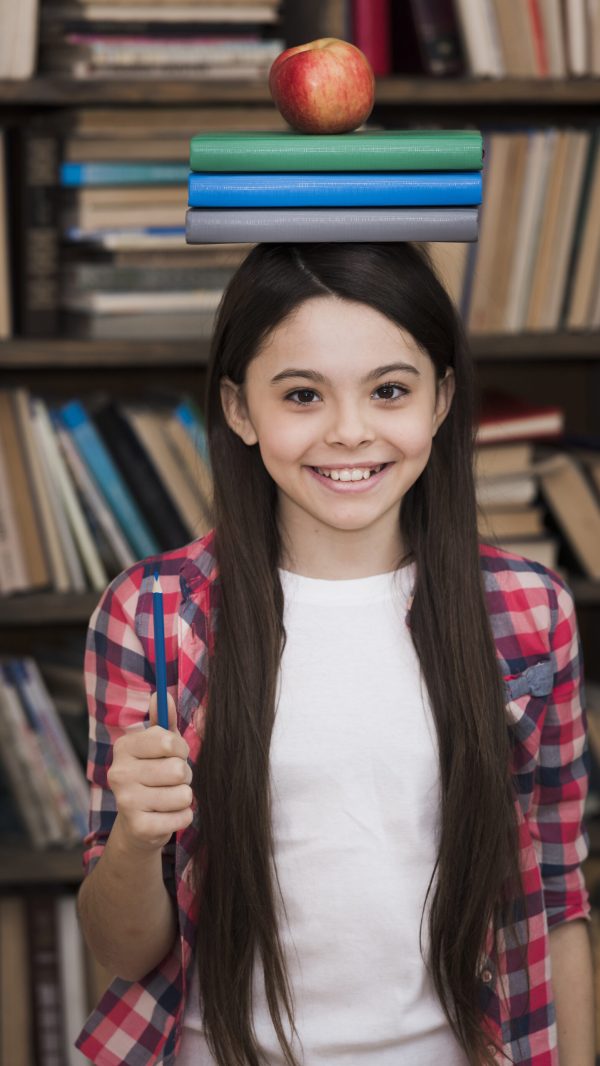 adorable-young-girl-holding-books-her-head